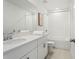 Well-lit bathroom with a single sink vanity, white cabinets, and a shower-tub combination at 1829 Draughton Dr, Zephyrhills, FL 33541