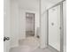 Modern bathroom featuring a glass-enclosed shower and an open view to a walk-in closet at 1829 Draughton Dr, Zephyrhills, FL 33541