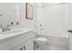 Clean, modern bathroom with white cabinets, marbled countertop, and bathtub/shower combo at 1829 Draughton Dr, Zephyrhills, FL 33541