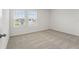 Bright bedroom with carpet, dual windows, and plenty of natural light at 1829 Draughton Dr, Zephyrhills, FL 33541