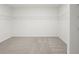 Spacious walk-in closet with ample wire shelving and neutral carpeting, ready for organization at 1829 Draughton Dr, Zephyrhills, FL 33541