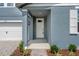 Inviting front entrance with a covered porch and well-maintained landscaping at 1829 Draughton Dr, Zephyrhills, FL 33541