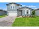 Charming two-story home with a two-car garage, landscaped yard, and inviting entrance at 1829 Draughton Dr, Zephyrhills, FL 33541