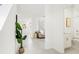 Hallway view leading to a bathroom, showing the home's layout and natural light at 1829 Draughton Dr, Zephyrhills, FL 33541