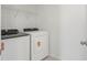 Convenient laundry room features a modern washer, dryer, and storage shelf at 1829 Draughton Dr, Zephyrhills, FL 33541