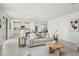 Bright and airy living room with modern decor, seamlessly connecting to the kitchen and dining area at 1829 Draughton Dr, Zephyrhills, FL 33541