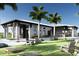 Relaxing outdoor area with chairs, a bar, and lawn games at the modern designed community clubhouse at 18421 Vista Park Ter, Venice, FL 34293