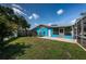 Exterior shot of the home's spacious backyard, showing a sunny patio and well-maintained lawn at 2020 58Th N Way, Clearwater, FL 33760