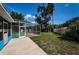Large backyard featuring a screened-in pool area and grassy lawn at 2020 58Th N Way, Clearwater, FL 33760