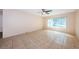 Neutral bedroom with tile flooring, ceiling fan, and a sunlit window with vertical blinds at 2020 58Th N Way, Clearwater, FL 33760