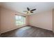 An inviting bedroom with hardwood floors, a ceiling fan, and a bright window offers relaxation at 2020 58Th N Way, Clearwater, FL 33760