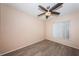 A cozy bedroom with hardwood floors, ceiling fan and a bright window awaits its new resident at 2020 58Th N Way, Clearwater, FL 33760