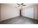 A spacious bedroom features hardwood floors, closet, ceiling fan, baseboard trim and natural light at 2020 58Th N Way, Clearwater, FL 33760