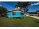 Bright home exterior with well manicured lawn and mature palm trees at 2020 58Th N Way, Clearwater, FL 33760