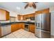 Updated kitchen with stainless appliances, oak cabinets, dark countertops, and tile flooring, bright and airy at 2020 58Th N Way, Clearwater, FL 33760