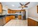 Well-equipped kitchen with stainless steel appliances, oak cabinets, black countertops, and tile floors at 2020 58Th N Way, Clearwater, FL 33760