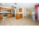 Spacious kitchen with stainless appliances, tile flooring, and an island, perfect for entertaining at 2020 58Th N Way, Clearwater, FL 33760