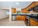 Well-lit kitchen featuring wood cabinets, granite countertops, and stainless steel appliances at 2020 58Th N Way, Clearwater, FL 33760