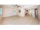 Open living room with tiled flooring, ceiling fan and access to different areas of the home at 2020 58Th N Way, Clearwater, FL 33760