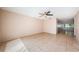 Large living room with neutral walls, tile flooring, ceiling fan, and natural light streaming in from the windows at 2020 58Th N Way, Clearwater, FL 33760