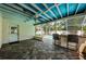 Covered patio with screened windows, bar and stools that overlook the refreshing pool at 2020 58Th N Way, Clearwater, FL 33760