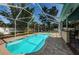 Spacious screened-in pool area with pavers, lush landscaping, and room to relax at 2020 58Th N Way, Clearwater, FL 33760