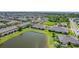 Expansive aerial view of residential community with pond, clubhouse, pool, and well-kept lawns at 2022 Hawks View Dr, Ruskin, FL 33570