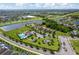Aerial view of community featuring a pool, playground, and a lake nearby at 2022 Hawks View Dr, Ruskin, FL 33570