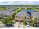 Panoramic aerial shot of townhomes near a peaceful pond, solar panels, and a well-maintained community at 2022 Hawks View Dr, Ruskin, FL 33570