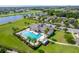 Aerial view of community featuring a pool, clubhouse, and lush landscaping at 2022 Hawks View Dr, Ruskin, FL 33570