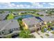 Scenic aerial view showcasing townhomes near a tranquil pond with lush greenery, and solar panels at 2022 Hawks View Dr, Ruskin, FL 33570