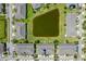 Scenic aerial view of community homes surrounding a pond with lush green spaces and parking at 2022 Hawks View Dr, Ruskin, FL 33570