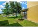 Lawn view of pond from a screened lanai, with mature trees for added privacy at 2022 Hawks View Dr, Ruskin, FL 33570
