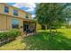 Inviting backyard featuring a screened lanai, lush landscaping, and mature trees for added privacy at 2022 Hawks View Dr, Ruskin, FL 33570