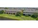 A serene backyard view of the condo showcasing a pond view and screened lanai surrounded by lush greenery at 2022 Hawks View Dr, Ruskin, FL 33570