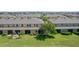 This condo backyard features a pond view and a cozy screened lanai surrounded by manicured landscaping at 2022 Hawks View Dr, Ruskin, FL 33570