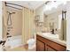 Bathroom with a shower and tub combo and wooden vanity at 2022 Hawks View Dr, Ruskin, FL 33570