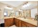 Bright bathroom featuring double sinks, large mirrors, and modern lighting at 2022 Hawks View Dr, Ruskin, FL 33570