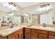 Double sink bathroom with tan countertops, and an expansive mirror wall at 2022 Hawks View Dr, Ruskin, FL 33570