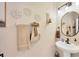 A half-bathroom with pedestal sink, decorative wall accents, and modern fixtures at 2022 Hawks View Dr, Ruskin, FL 33570
