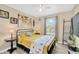 Cozy bedroom featuring a metal bed frame, end tables and floral decor at 2022 Hawks View Dr, Ruskin, FL 33570