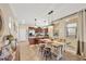 Open dining area features a rustic wood table with a view to the kitchen and natural light at 2022 Hawks View Dr, Ruskin, FL 33570