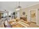Open-plan dining area with rustic table near the living room and access to other rooms at 2022 Hawks View Dr, Ruskin, FL 33570