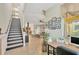 Inviting entryway features staircase and tiled floors leading into the living area with natural light at 2022 Hawks View Dr, Ruskin, FL 33570