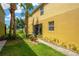 The condo exterior shows lush lawn, palm trees, and manicured landscape beds surrounding property at 2022 Hawks View Dr, Ruskin, FL 33570