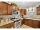 View of the kitchen showcasing granite countertops, stainless steel appliances, and wood cabinets at 2022 Hawks View Dr, Ruskin, FL 33570