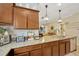 Shows an island kitchen with granite countertops, wooden cabinets, and modern fixtures at 2022 Hawks View Dr, Ruskin, FL 33570