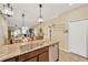Open kitchen with a granite island with seating, stainless appliances, and view into living area at 2022 Hawks View Dr, Ruskin, FL 33570
