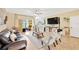 Open-plan living room with tile flooring and view of the lanai beyond sliding glass doors at 2022 Hawks View Dr, Ruskin, FL 33570
