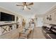 An open-concept living room with a ceiling fan, neutral walls, and tile floors at 2022 Hawks View Dr, Ruskin, FL 33570